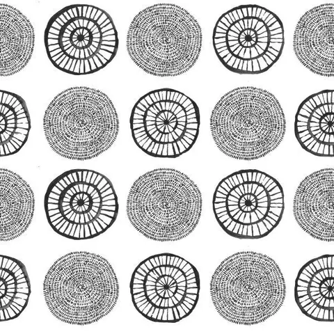 Black and white repeating pattern of concentric circles with radiating line details in boho style