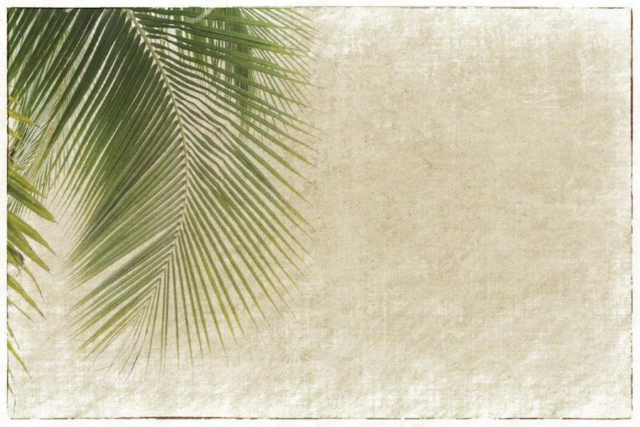 Green palm fronds on textured cream background with vintage finish