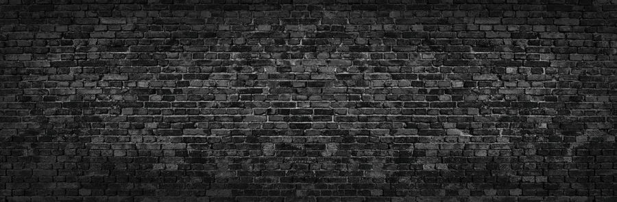 Dark charcoal brick wall texture with realistic mortar lines and weathered surface