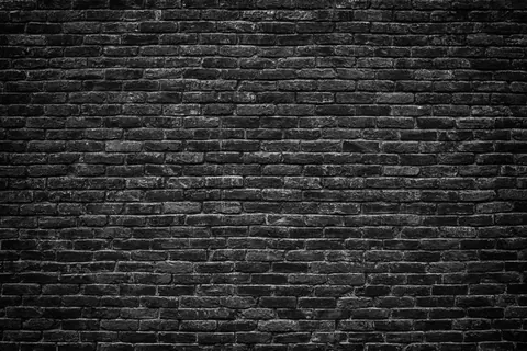 Dark charcoal brick wall texture with grey mortar lines and realistic weathered surface