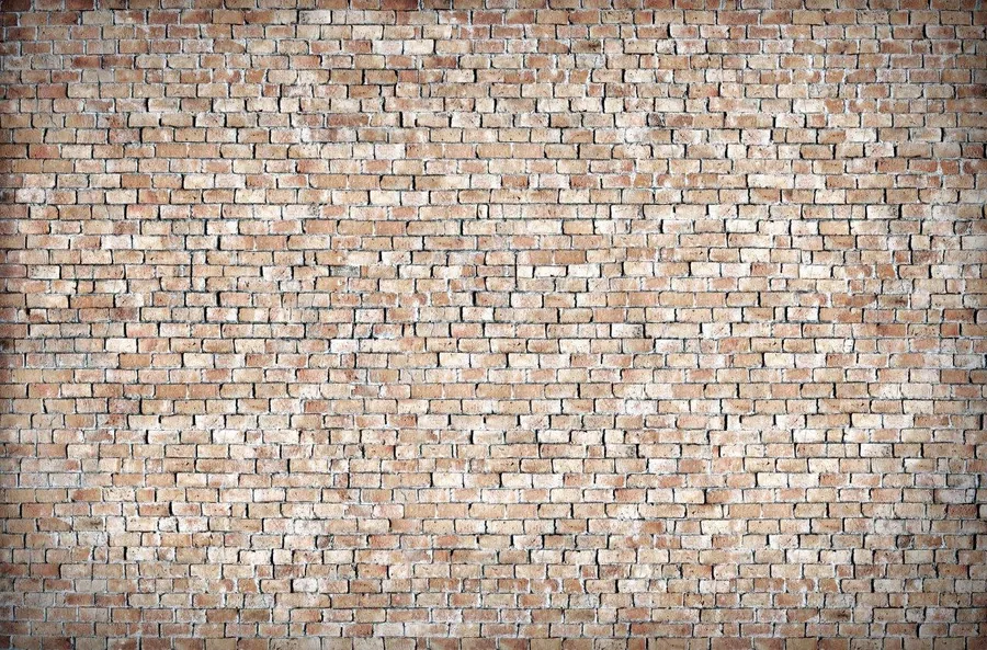 Close-up of a repeating brick wall pattern in warm red, terracotta, and cream tones.