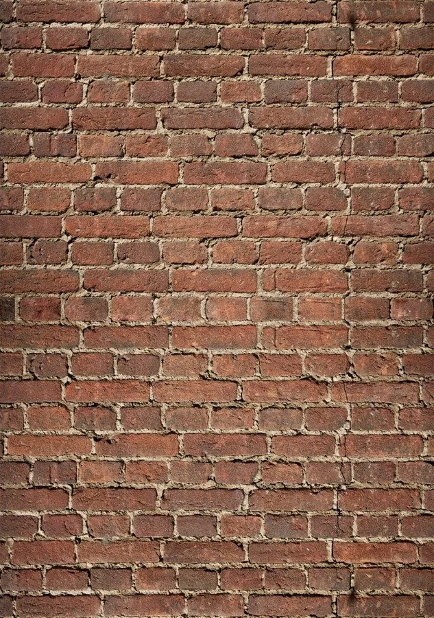 Close-up of weathered red brick wall with cream-colored mortar joints in running bond pattern.