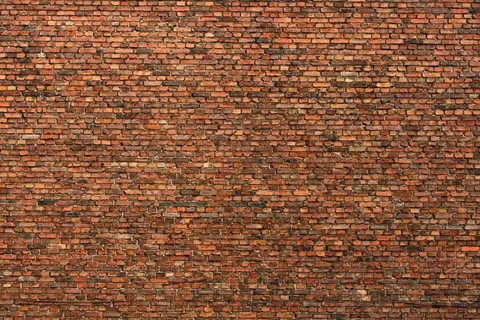 Seamless red and orange brick wall texture with natural mortar joints