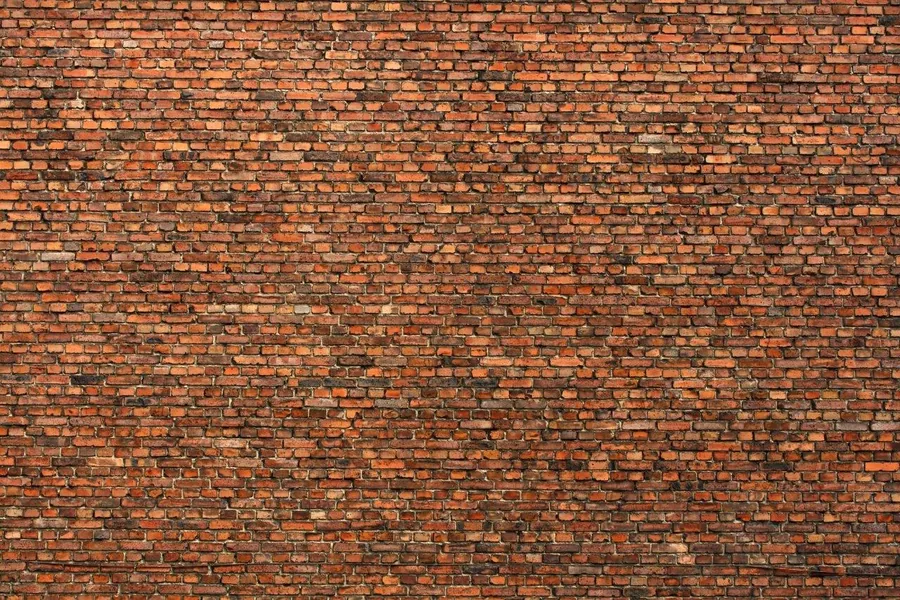 Seamless red and orange brick wall texture with natural mortar joints