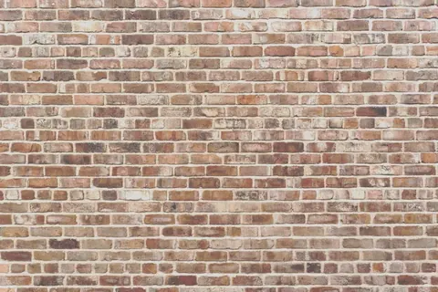 Seamless rustic red and brown brick wall texture with natural weathering and mortar lines.