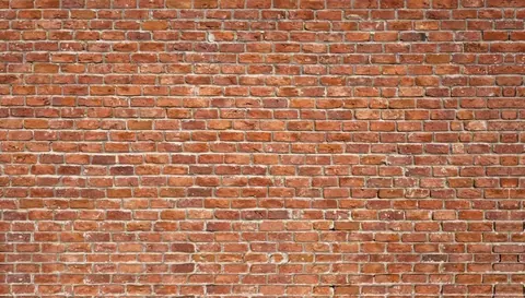 Seamless terracotta brick wall texture with grey mortar joints and natural weathering.