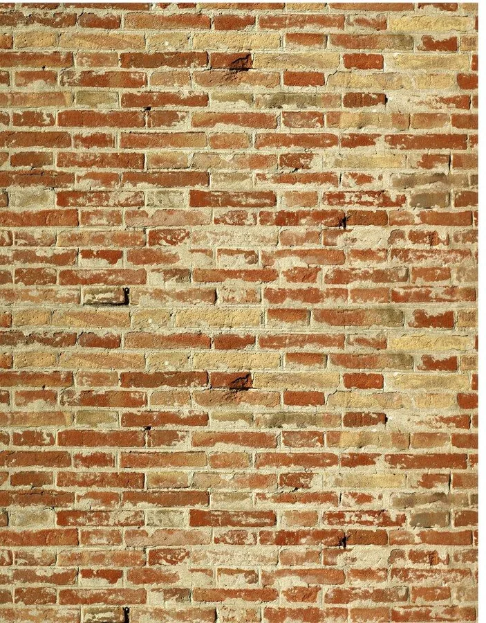 Repeating pattern of rustic red and cream brick wall texture with mortar joints