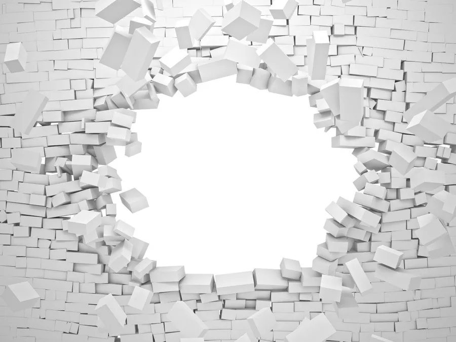White and grey cubic blocks exploding through a brick textured wall, creating a 3D breakthrough effect.
