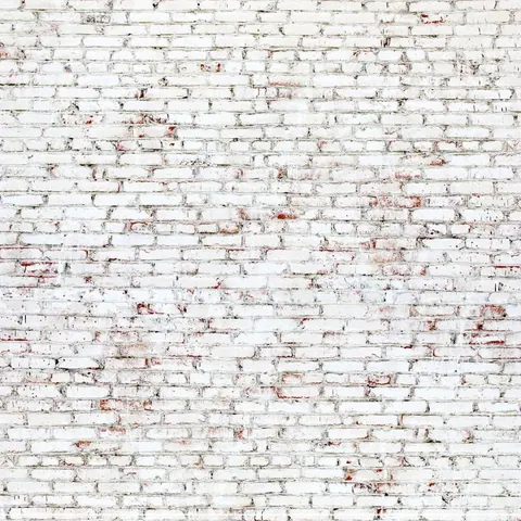 Weathered white painted brick wall with red and rust patina showing age and texture throughout