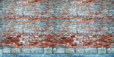Weathered brick wall with terracotta and blue-grey bricks showing age and texture patterns