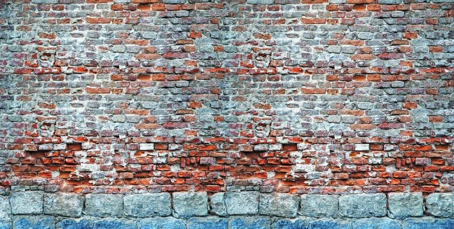 Weathered brick wall with terracotta and blue-grey bricks showing age and texture patterns