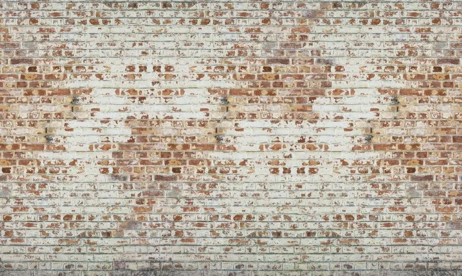 Distressed whitewashed brick wall texture with red and cream colored bricks in repeating pattern