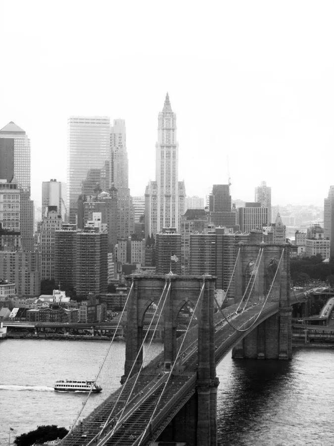 Black and white photograph of Manhattan skyline with Brooklyn Bridge and Chrysler Building