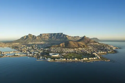 Aerial photograph of Cape Town with Table Mountain, coastal beaches, and blue ocean waters