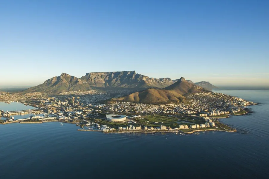 Aerial photograph of Cape Town with Table Mountain, coastal beaches, and blue ocean waters