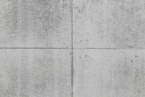 Four concrete panels with visible grout seams and speckled surface texture