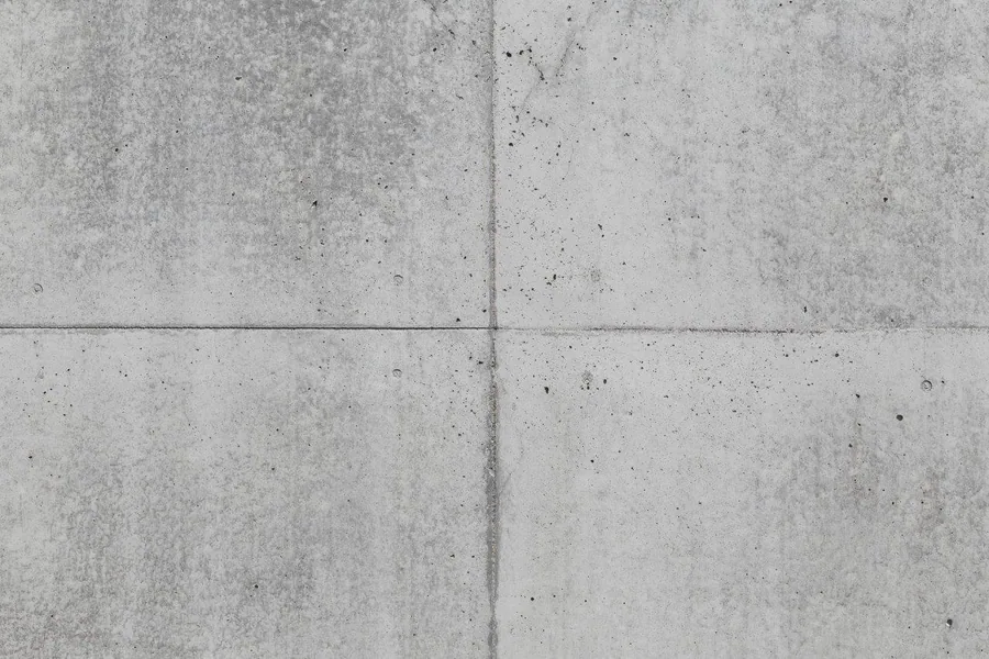 Four concrete panels with visible grout seams and speckled surface texture