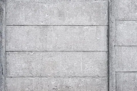Horizontal concrete block wall texture with subtle grout lines and natural grey variations.