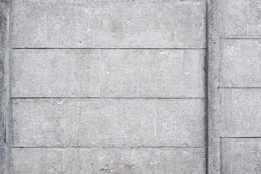 Horizontal concrete block wall texture with subtle grout lines and natural grey variations.