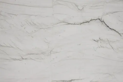 White marble texture with fine grey veining and natural striations throughout.