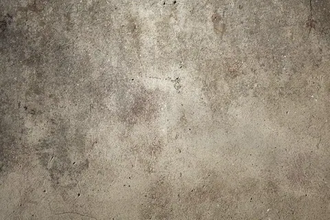Grungy concrete surface with weathered stains and natural texture variations