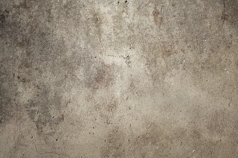Grungy concrete surface with weathered stains and natural texture variations
