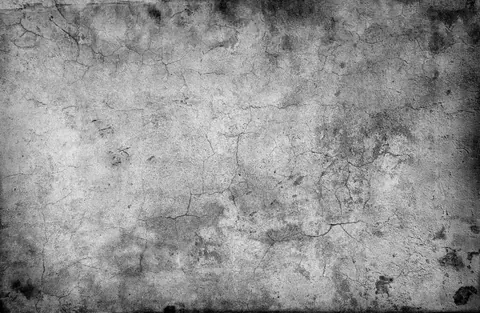 Grayscale concrete texture with fine cracks, stains, and weathered surface detail.