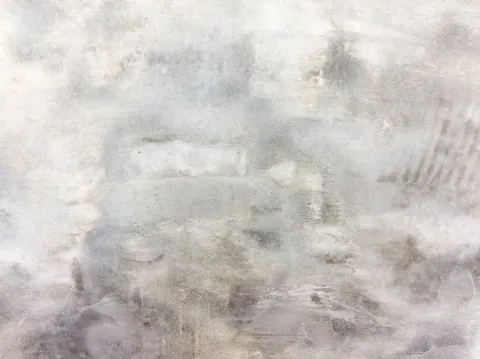 Soft gray weathered concrete texture with layered striations and subtle surface variations