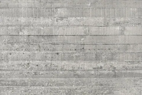 Horizontal concrete plank texture with weathered gray finish and natural discoloration.