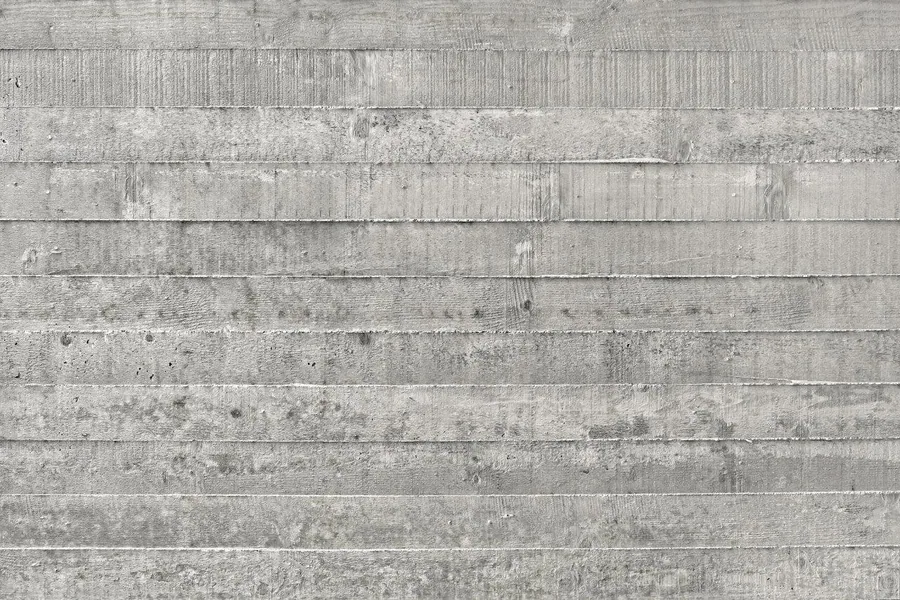 Horizontal concrete plank texture with weathered gray finish and natural discoloration.