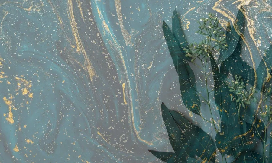 Dark green lotus leaves with gold veining floating in teal-blue water with botanical details