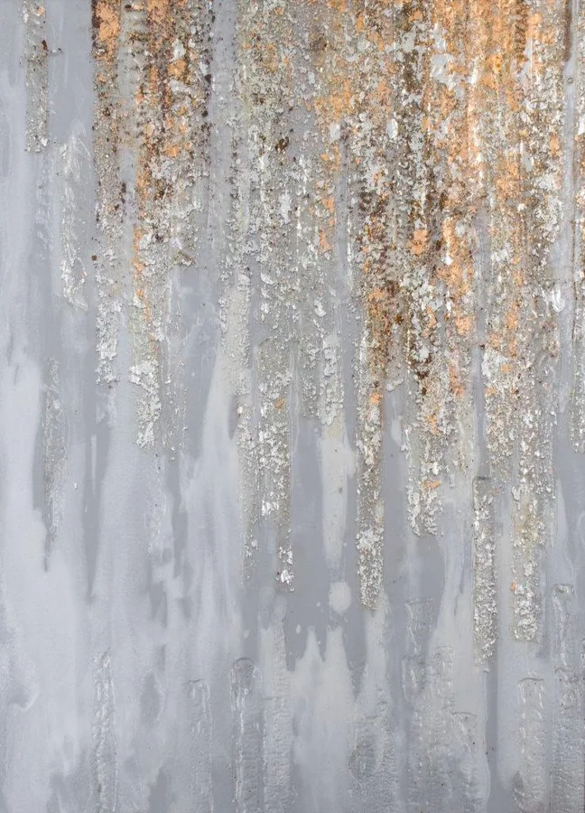 Vertical gold and cream drips on grey textured background with metallic shimmer effect