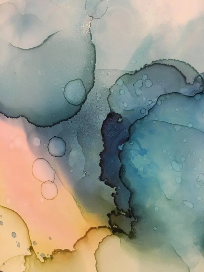 Abstract watercolour marble pattern with soft teal, peachy-pink, and yellow tones blending together with decorative bubbles