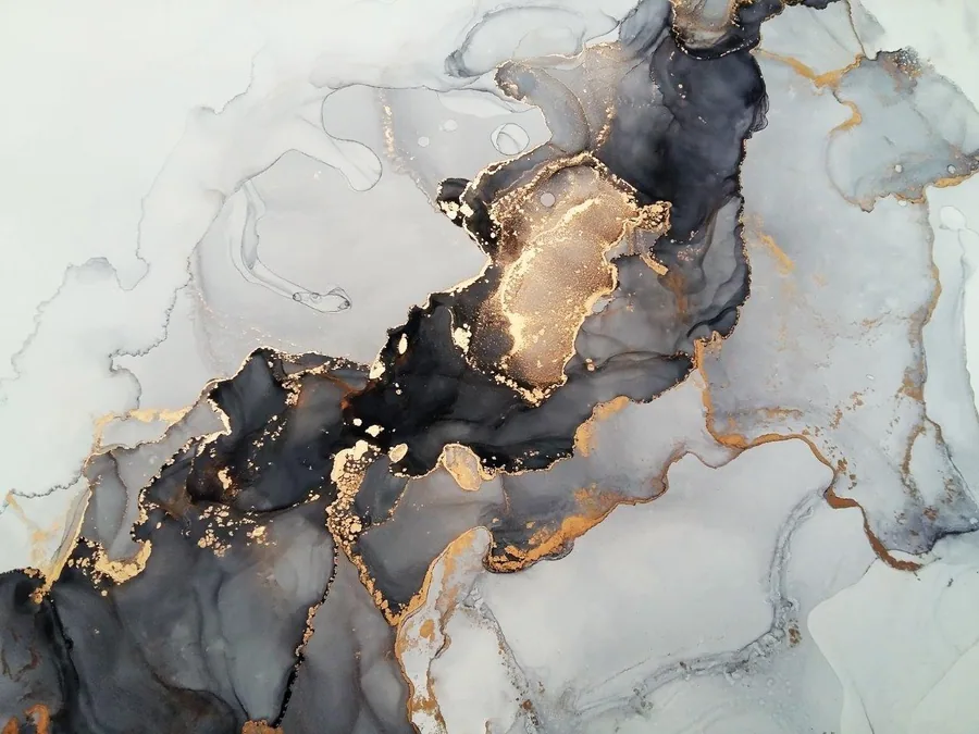 Abstract marble texture with deep black, charcoal, gold leaf accents, and cream swirls.
