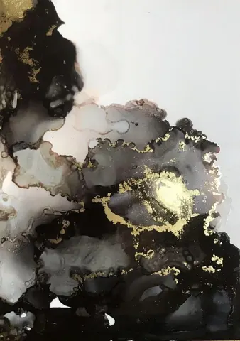 Abstract marble texture with black, gray, and white regions accented by shimmering gold veining and metallic details