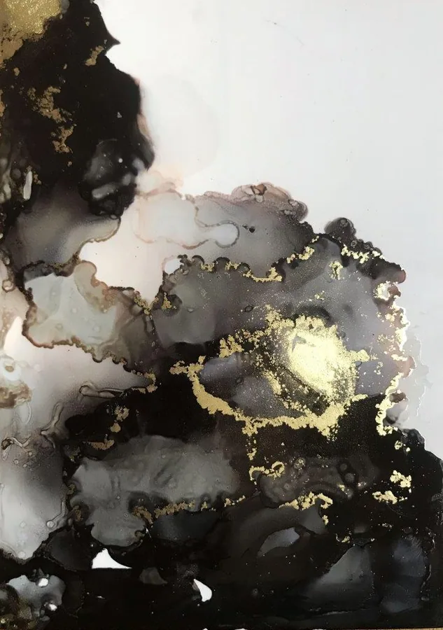 Abstract marble texture with black, gray, and white regions accented by shimmering gold veining and metallic details