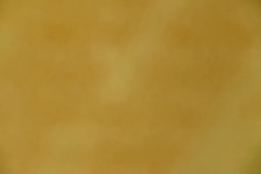 Warm gold textured surface with subtle brushstroke patterns and metallic sheen