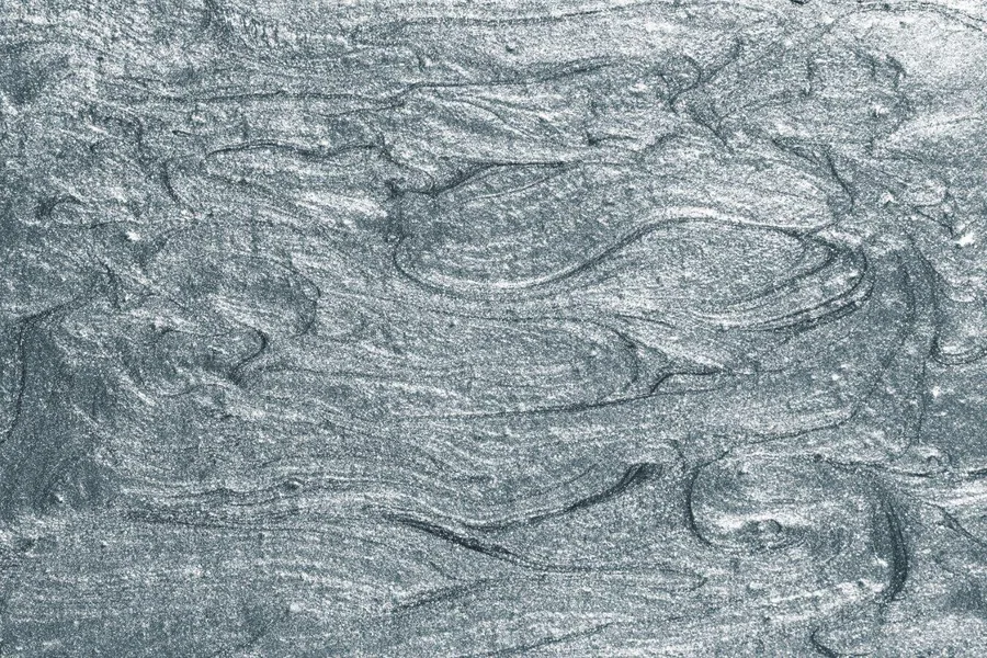 Grey metallic wallpaper with flowing wave texture and brushed steel finish