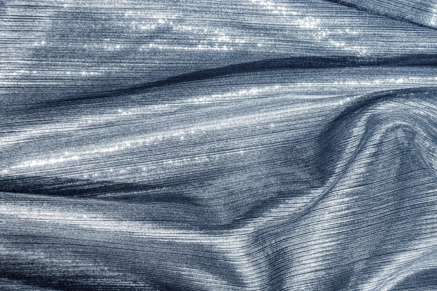 Brushed metal texture with flowing wave patterns in silver and gray tones