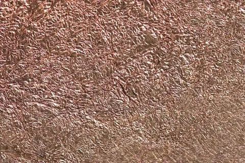 Crinkled copper metallic texture with warm bronze highlights and dimensional wrinkled surface