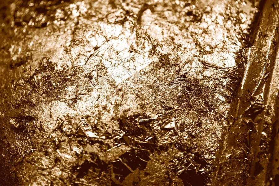 Gold and bronze metallic texture with crystalline veining and mineral-like surface patterns