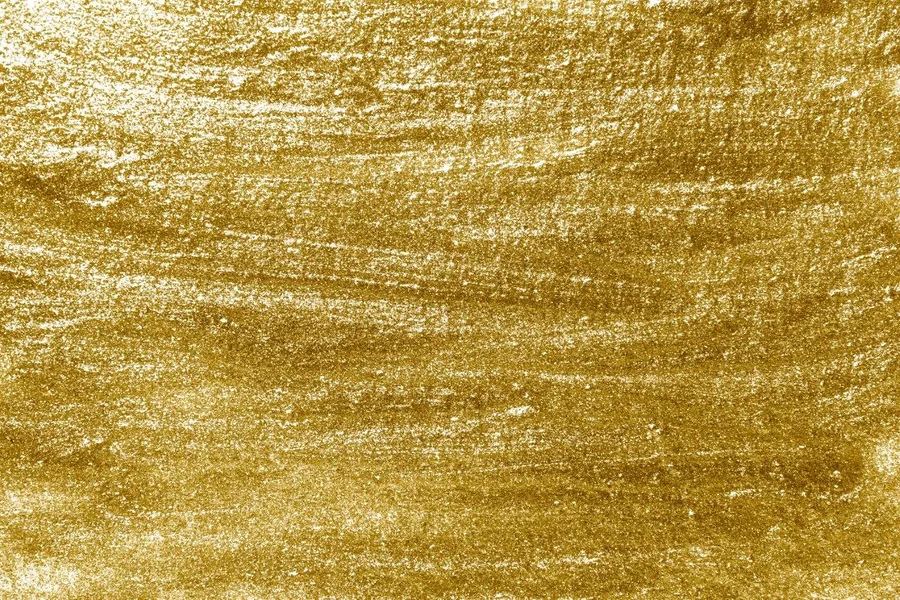Gold and white textured metallic surface with brushstroke effect