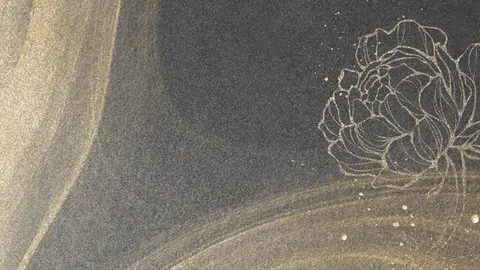 Dark charcoal background with golden line-drawn lotus flower and flowing metallic brushstrokes