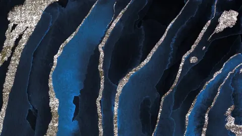 Abstract aerial view of deep blue and black channels separated by shimmering metallic silver borders
