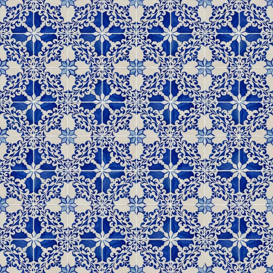 Blue and white ornate mosaic tile pattern with baroque scrollwork in repeating geometric design