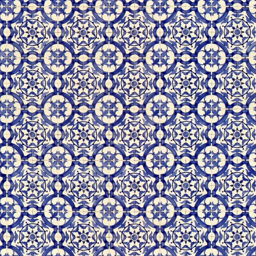 Repeating blue and cream geometric mosaic tile pattern with stars and circular ornaments