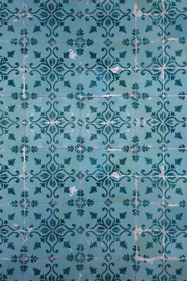 Repeating blue mosaic tile pattern with ornate damask and floral motifs
