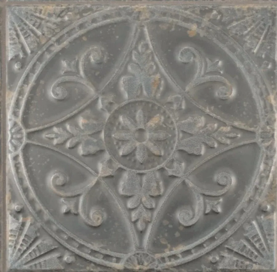 Grey stone tile with ornate carved medallion, scrolls, and central floral design