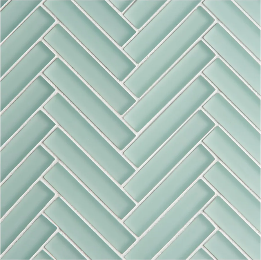 Repeating herringbone tile pattern in seafoam green with white grout lines creating geometric texture