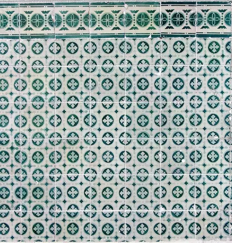 Repeating teal and cream mosaic tile pattern with geometric compass flowers and ornamental details